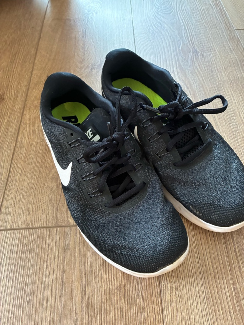 Nike women’s black running shoe. With white swoosh. Size 9.5 (euro 41)